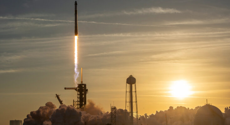 a rocket launches into a sunset sky