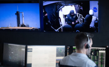 Monitors show a SpaceX Falcon 9 rocket carrying the company's Dragon spacecraft and members of the closeout crew during a dress rehearsal in preparation for the launch of NASA’s SpaceX Crew-11 mission.