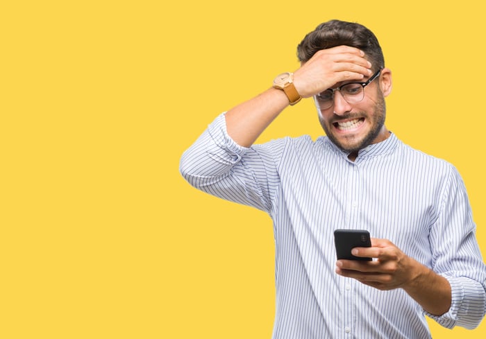 Una persona que mira el teléfono y una cabeza de sujeción.