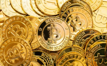 Gold coins with Bitcoin logo on them.