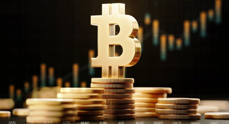 The Bitcoin symbol atop stacks of coins with an upward-trending price chart in the background.