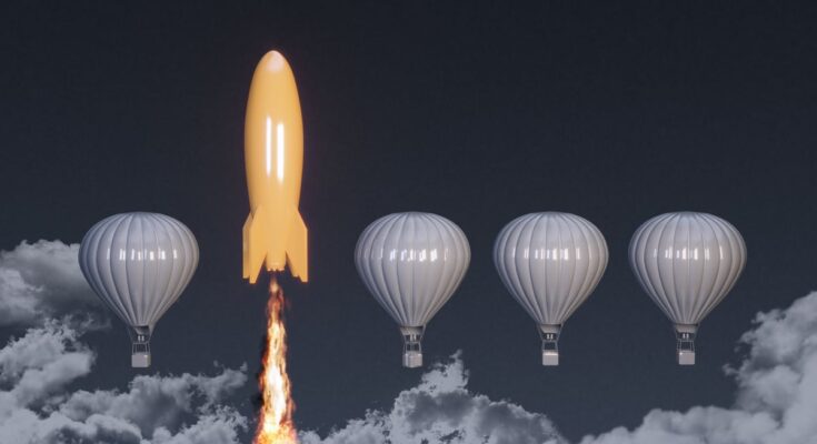 Rocket ship soaring past hot air balloons.