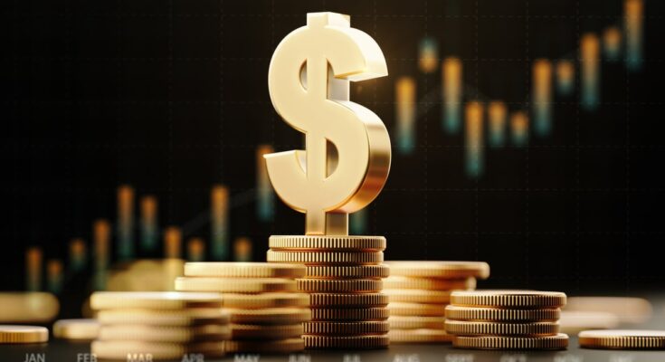 A gold dollar sign on top of stacked gold coins with an upward-trending price chart in the background.