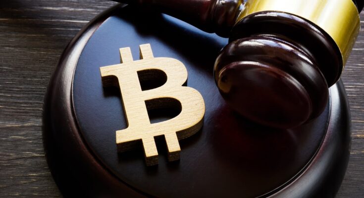 The Bitcoin symbol with a gavel next to it.