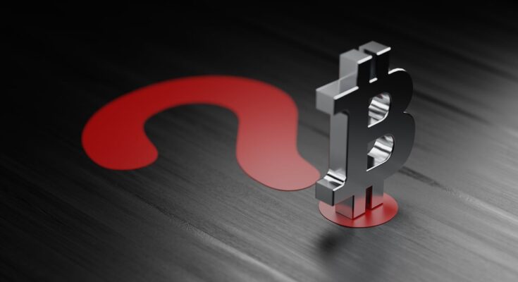 A silver Bitcoin-logo figurine on a large red question mark.