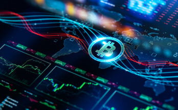 A Bitcoin logo rests on a tablet screen displaying a map of the world and stock price data.