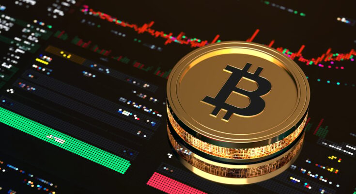Gold Bitcoin on top of digital trading screen.