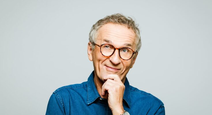 Skeptical investor with hand on chin, thinking.