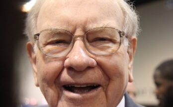 A jubilant Warren Buffett surrounded by people at Berkshire Hathaway's annual shareholder meeting.