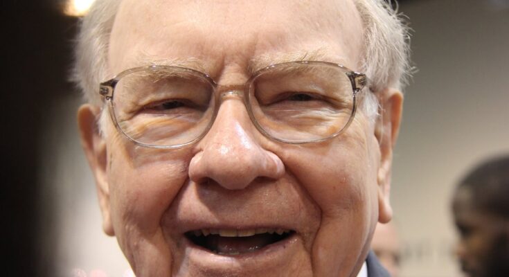 A jubilant Warren Buffett surrounded by people at Berkshire Hathaway's annual shareholder meeting.