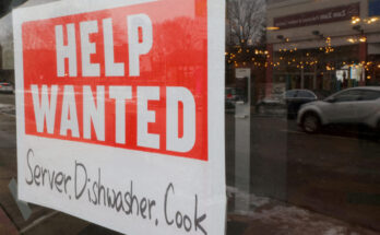 FILE PHOTO: A “Help Wanted” sign hangs in restaurant window in Medford